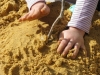 primary school nursery child playing in sand